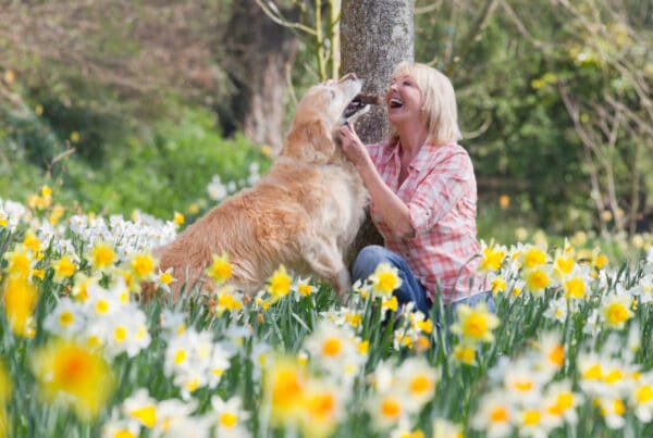 Woman Outside Petting Dog
